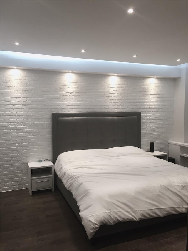 bedroom with recessed lighting and wood finished floors