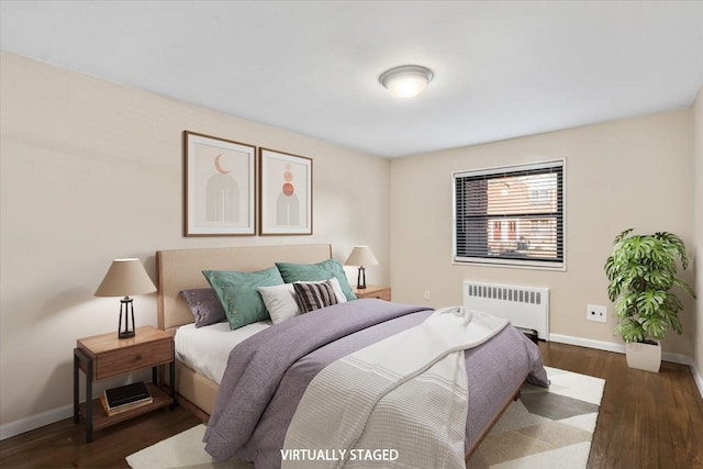 bedroom featuring baseboards, radiator, and wood finished floors