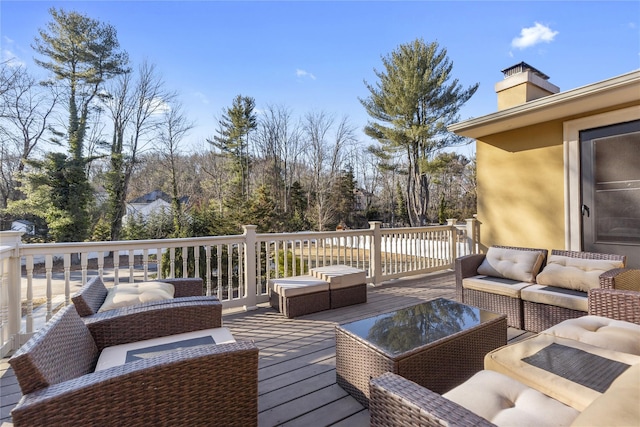 wooden terrace featuring an outdoor living space