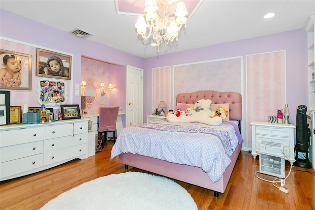 bedroom featuring recessed lighting, visible vents, a notable chandelier, and wood finished floors