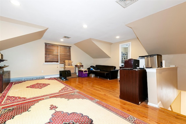 interior space featuring recessed lighting, visible vents, light wood-style flooring, and vaulted ceiling