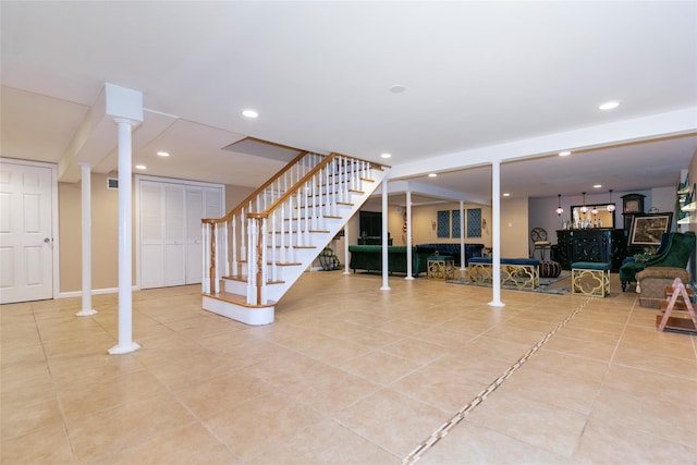 below grade area with stairs, a bar, recessed lighting, and tile patterned flooring