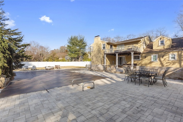 view of patio with outdoor dining space and fence