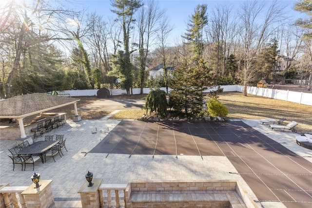 exterior space with a patio area, outdoor dry bar, and a fenced backyard