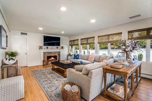 living area with recessed lighting, visible vents, and light wood-style flooring