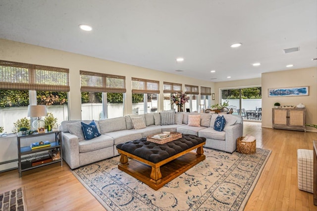 living area with recessed lighting and light wood-type flooring