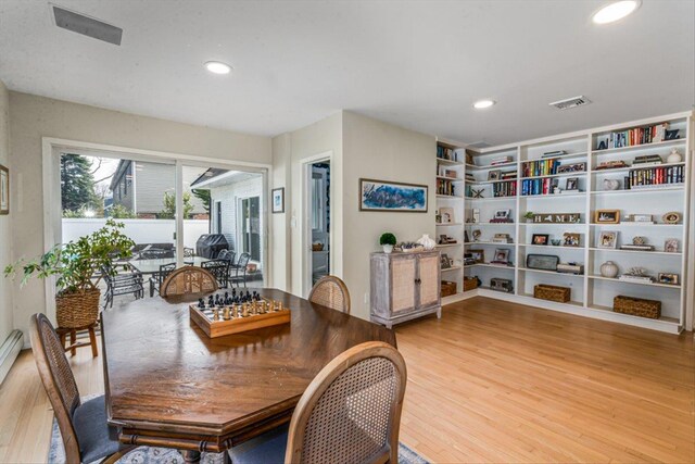 dining space featuring visible vents, recessed lighting, built in shelves, and wood finished floors