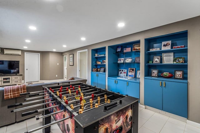recreation room with light tile patterned floors, recessed lighting, built in shelves, and a wall mounted air conditioner