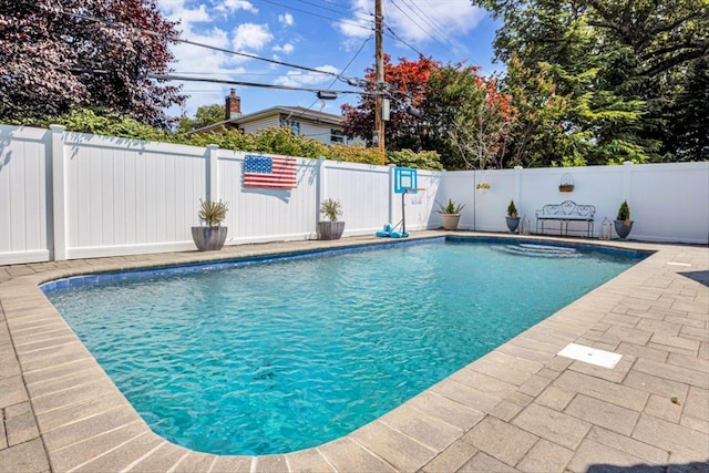view of swimming pool with a fenced in pool, a fenced backyard, and a patio area