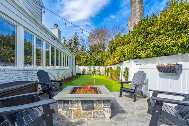 view of patio featuring a fire pit and a fenced backyard