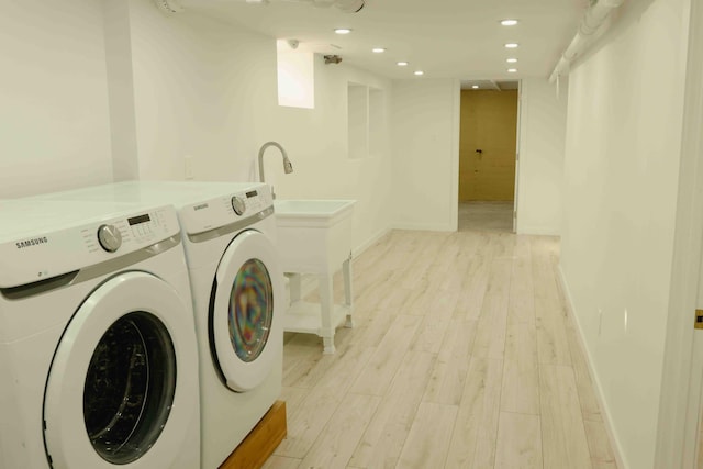 washroom with baseboards, laundry area, light wood-style flooring, recessed lighting, and washer and dryer