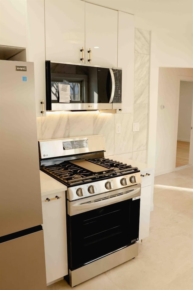 kitchen featuring white cabinets, appliances with stainless steel finishes, and light countertops