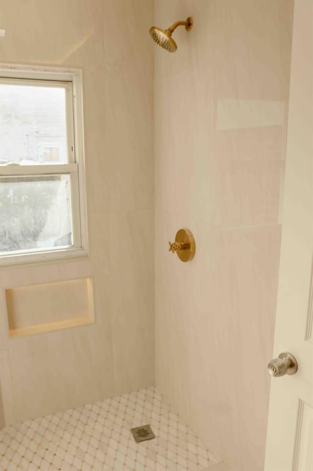 full bath with a tile shower