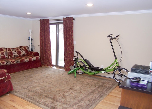 living area featuring recessed lighting, a healthy amount of sunlight, wood finished floors, and ornamental molding