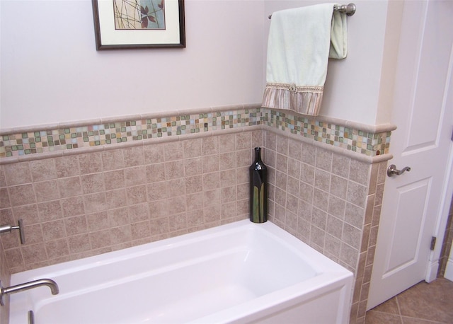 full bath with tile patterned floors, a wainscoted wall, tile walls, and a bath