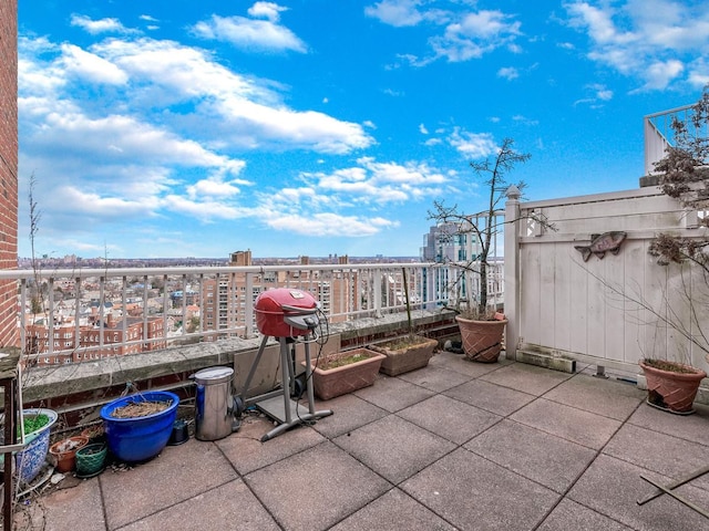 view of patio / terrace featuring grilling area, a city view, and a balcony