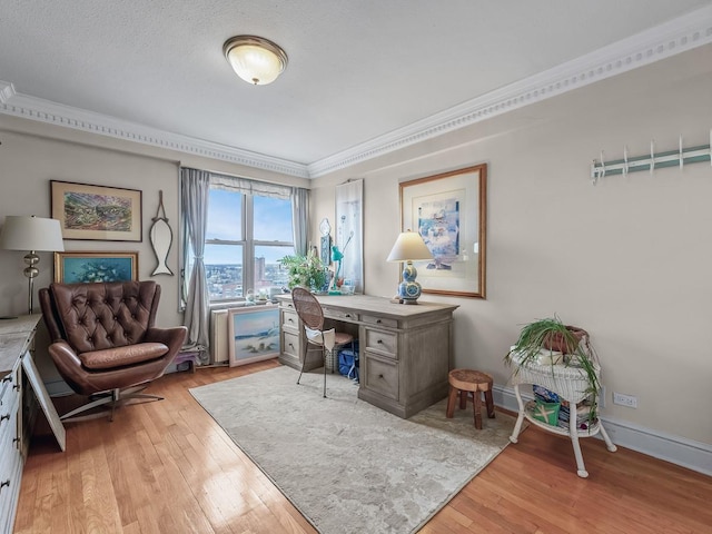 office with crown molding, baseboards, and light wood finished floors