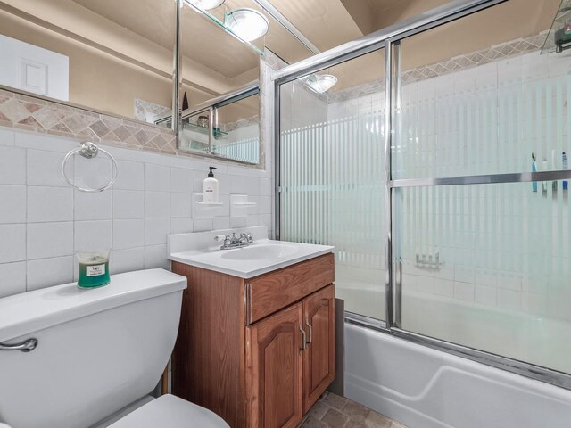 10740 Queens Blvd Pha, Pha, Forest Hills, NY 11375 - full bath featuring toilet, vanity, combined bath / shower with glass door, tile walls, and stone finish flooring