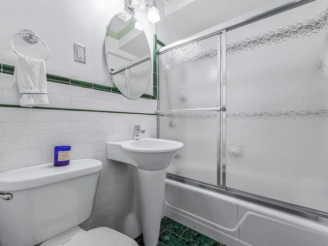 10740 Queens Blvd Pha, Pha, Forest Hills, NY 11375 - full bathroom with toilet, enclosed tub / shower combo, tile walls, and a wainscoted wall
