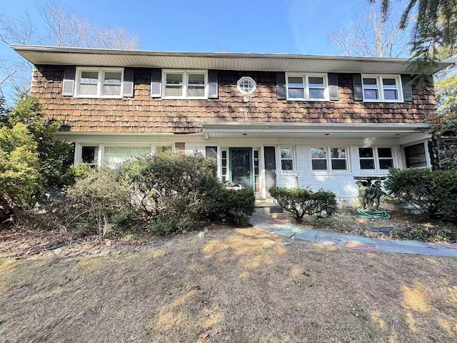 view of front of house featuring a garage and brick siding