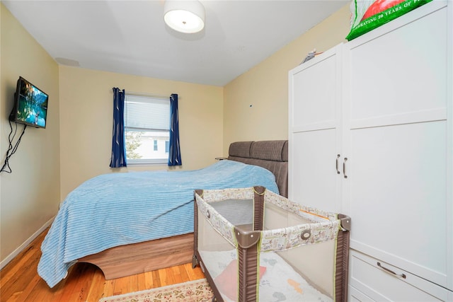 bedroom with baseboards and light wood-style flooring