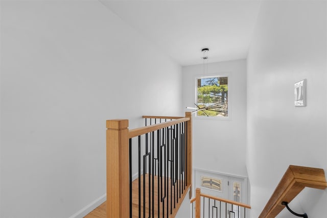 stairs featuring wood finished floors and baseboards