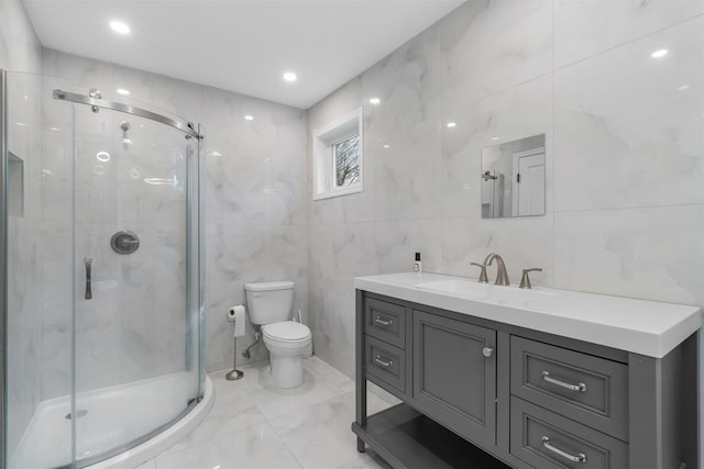 bathroom with a shower stall, toilet, and vanity