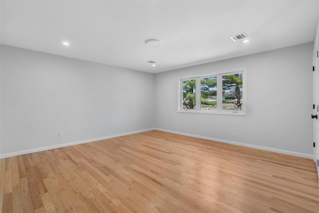 unfurnished room with recessed lighting, baseboards, visible vents, and light wood finished floors