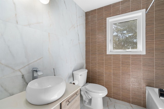 bathroom featuring walk in shower, a washtub, toilet, vanity, and tile walls