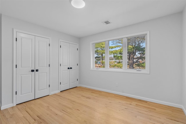 250 Blauvelt Rd, Pearl River, NY 10965 - unfurnished bedroom with two closets, baseboards, light wood-style floors, and visible vents