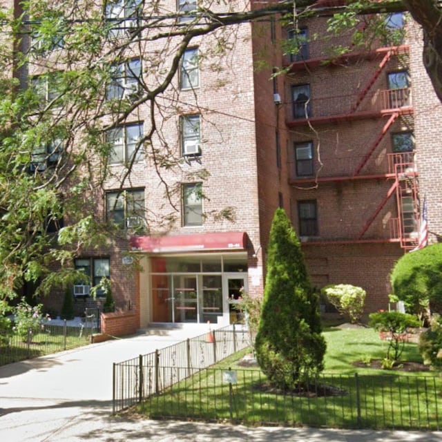 view of building exterior with a fenced front yard