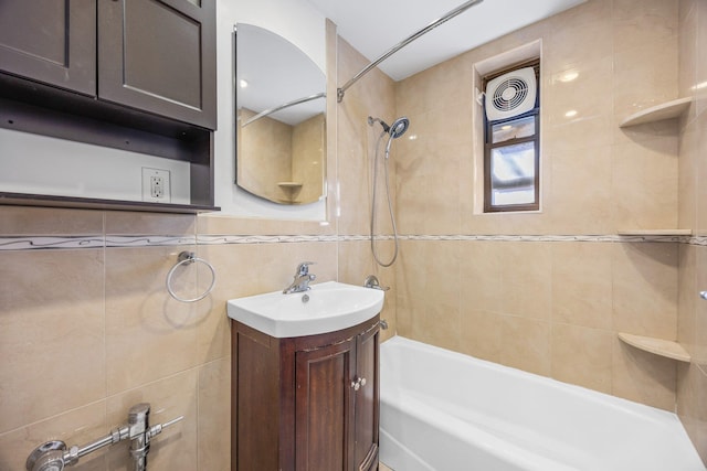 bathroom featuring vanity, tile walls, and shower / bathtub combination