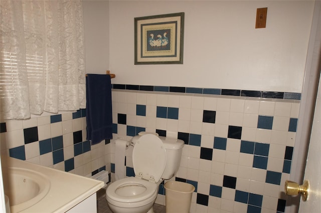 half bathroom featuring toilet and vanity