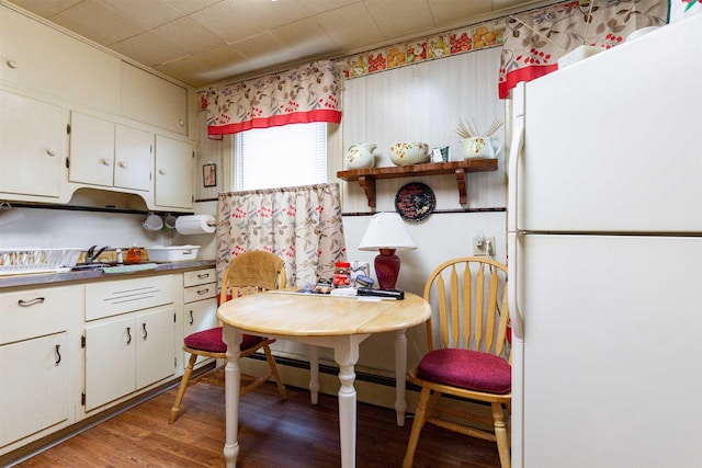 kitchen with white cabinets, light wood-type flooring, and freestanding refrigerator