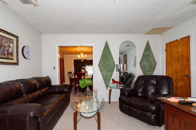 carpeted living area with a chandelier