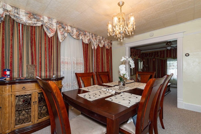 carpeted dining space featuring baseboards and a notable chandelier