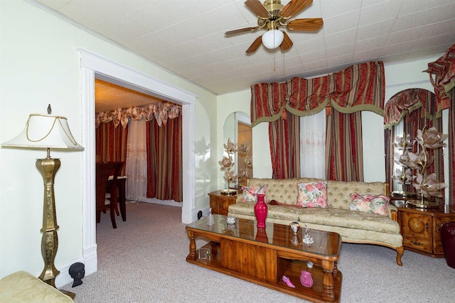 living area with ceiling fan and carpet flooring