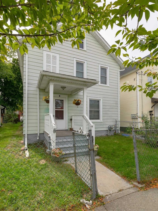 view of front of property featuring a front yard, a gate, and fence