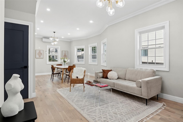 living area featuring ornamental molding, light wood-type flooring, and a chandelier