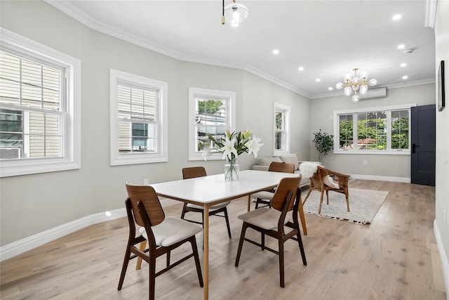 dining area featuring light wood-style flooring, baseboards, and ornamental molding