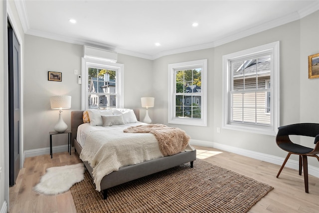 bedroom featuring crown molding, multiple windows, and a wall mounted air conditioner