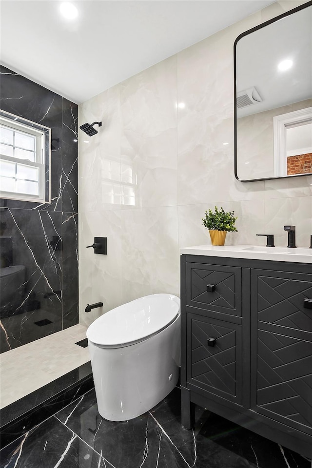 bathroom featuring tile walls, walk in shower, toilet, marble finish floor, and vanity