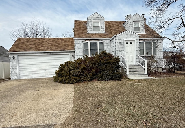 cape cod house featuring an attached garage, driveway, and a shingled roof