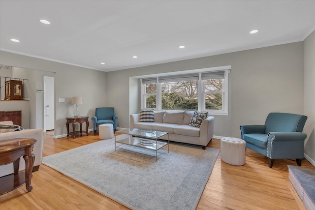 living area with crown molding, recessed lighting, baseboards, and light wood-type flooring