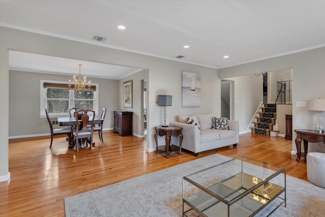 living room featuring visible vents, baseboards, light wood-type flooring, stairs, and a notable chandelier