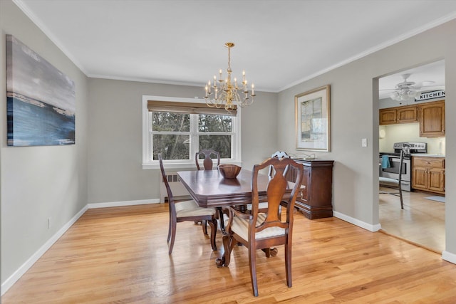 dining space featuring ceiling fan with notable chandelier, crown molding, light wood-type flooring, and baseboards