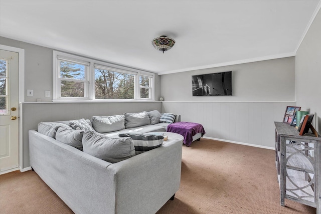 living area featuring carpet floors, wainscoting, and crown molding