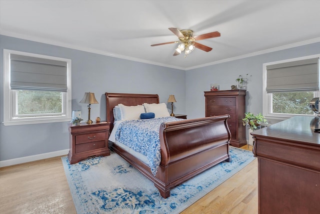 bedroom featuring baseboards, crown molding, and light wood finished floors