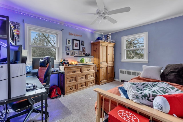 carpeted bedroom with multiple windows, radiator, ceiling fan, and crown molding