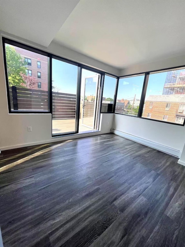 empty room featuring baseboards and wood finished floors